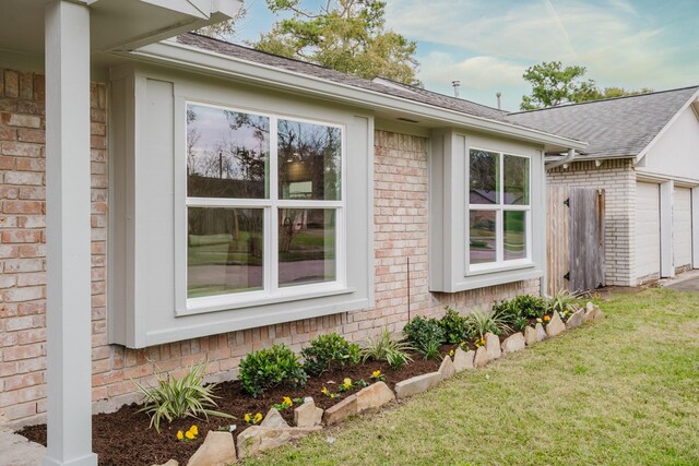 view of side of home with a yard