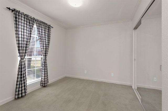 carpeted spare room with ornamental molding