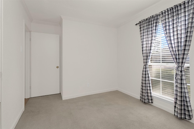 spare room featuring ornamental molding and light colored carpet