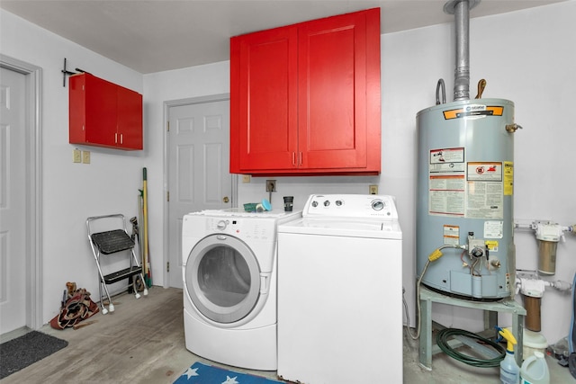 clothes washing area with water heater, cabinets, and washing machine and clothes dryer