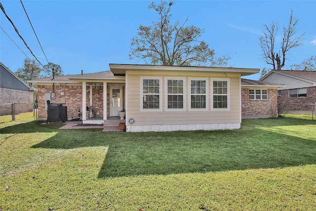 back of house featuring a lawn