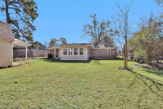 rear view of property with a yard