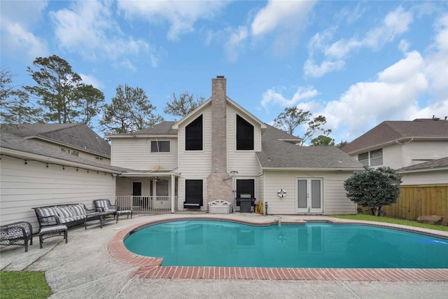 view of swimming pool with a patio area, ceiling fan, and area for grilling