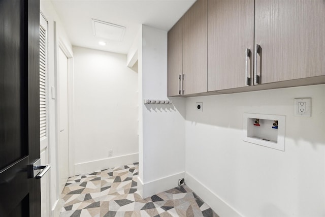 clothes washing area with cabinets, hookup for an electric dryer, and washer hookup