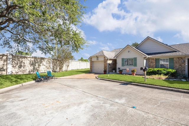 view of front of property featuring a front yard and a garage