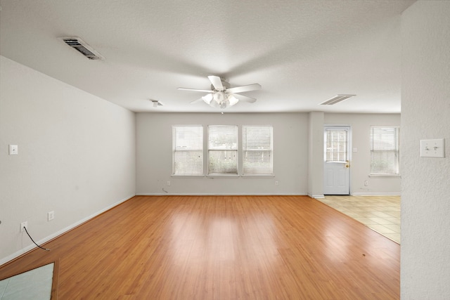 unfurnished living room with ceiling fan and light hardwood / wood-style flooring