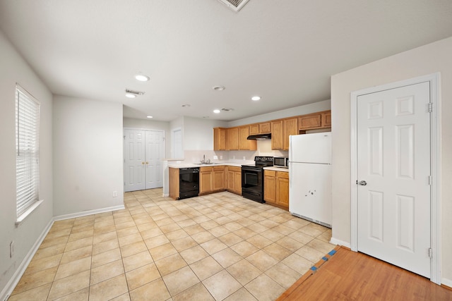 kitchen with sink, light tile patterned floors, and black appliances