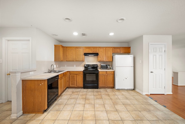 kitchen with sink, light tile patterned floors, and black appliances