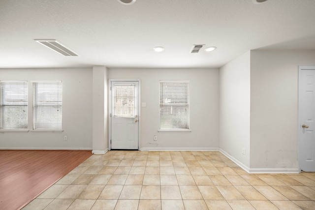 foyer entrance featuring light tile patterned floors