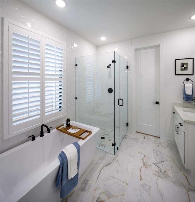 bathroom featuring independent shower and bath and vanity