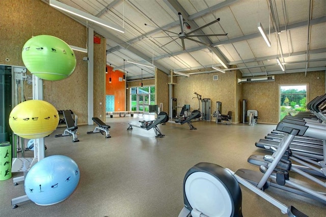 workout area with ceiling fan and high vaulted ceiling