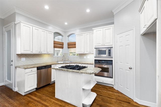 kitchen with white cabinetry, sink, a kitchen island, and appliances with stainless steel finishes