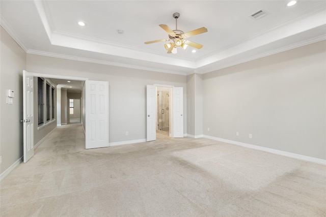 unfurnished bedroom with light carpet, crown molding, a raised ceiling, and ceiling fan