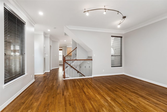 spare room with ornamental molding, dark hardwood / wood-style floors, and track lighting