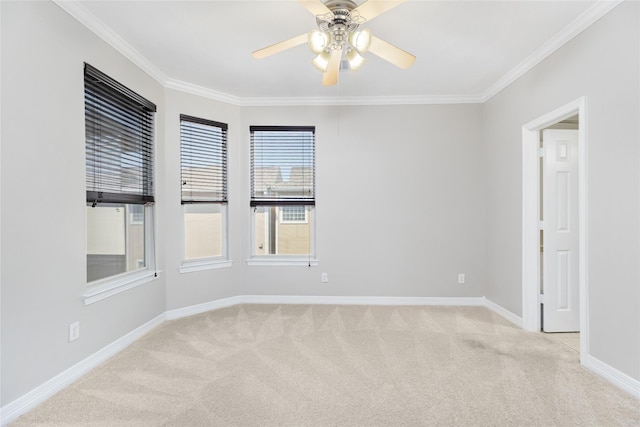 spare room with ceiling fan, light colored carpet, and ornamental molding