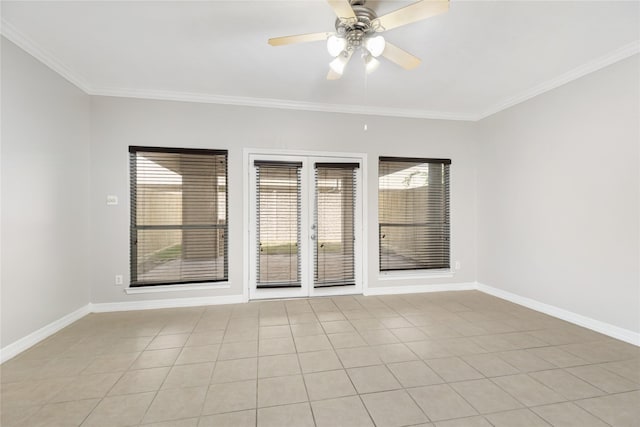 tiled empty room featuring ceiling fan and ornamental molding