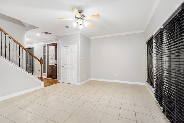 spare room featuring ornamental molding, light tile patterned floors, and ceiling fan