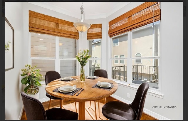 dining space with crown molding