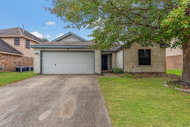 view of front of property with central air condition unit, a front yard, and a garage