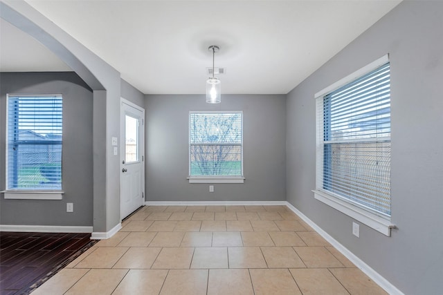 unfurnished dining area with light tile patterned floors