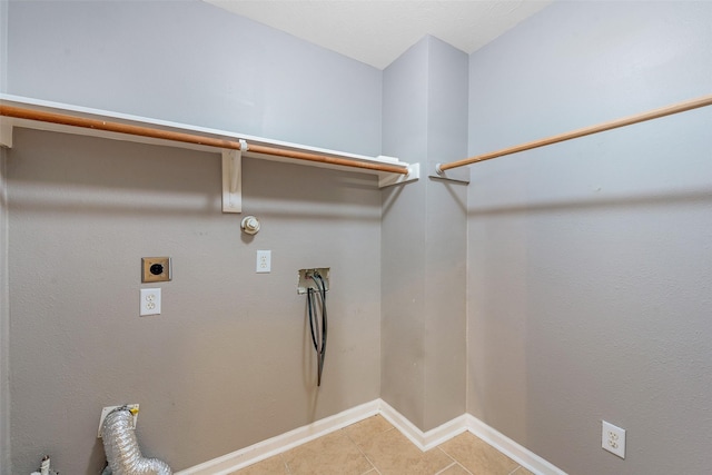 washroom with gas dryer hookup, tile patterned flooring, electric dryer hookup, and hookup for a washing machine