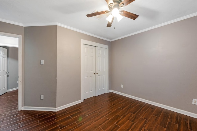 unfurnished bedroom with ceiling fan, a closet, and crown molding