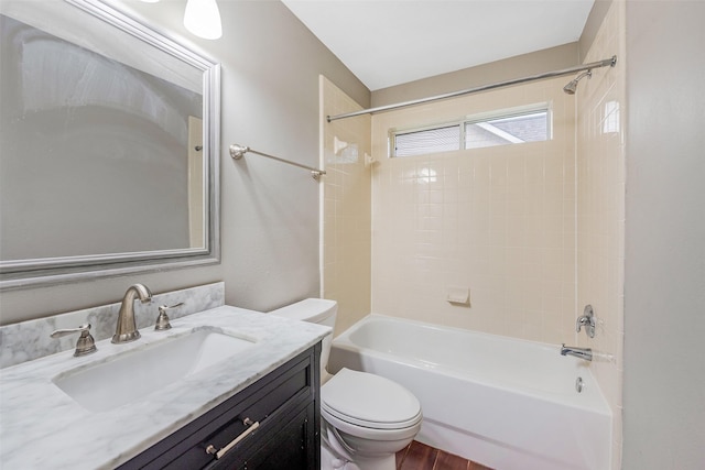 full bathroom featuring toilet, tiled shower / bath, and vanity