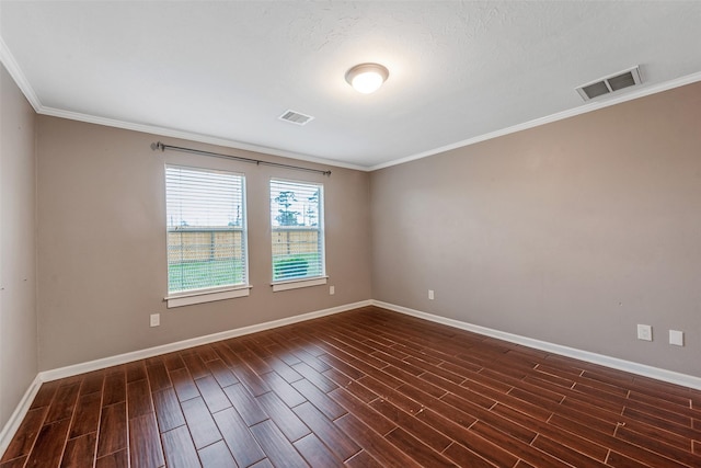 empty room featuring a textured ceiling and crown molding