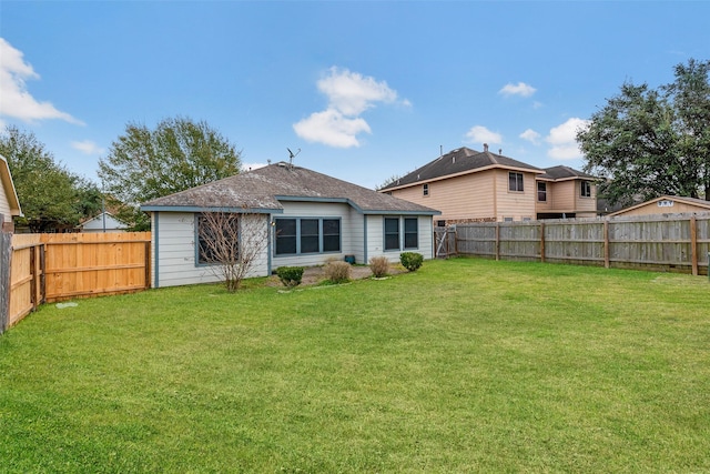 rear view of property featuring a yard