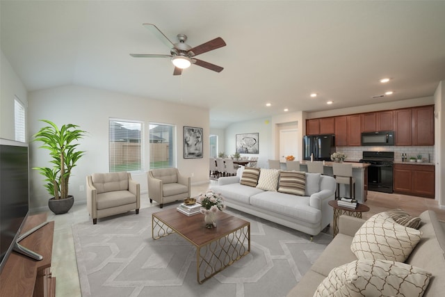 living room featuring lofted ceiling and ceiling fan