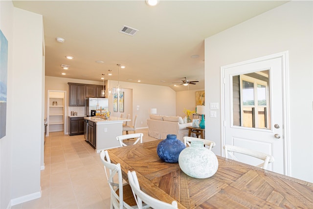 dining space with light tile patterned floors and ceiling fan