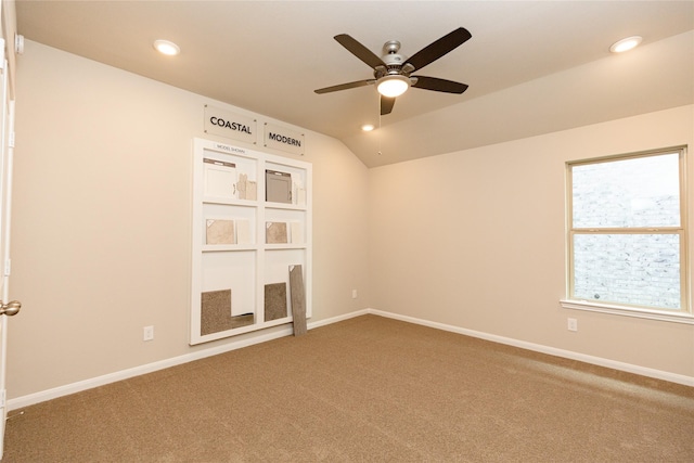 carpeted empty room with ceiling fan and vaulted ceiling