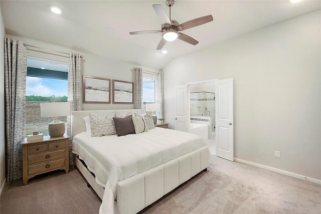 carpeted bedroom with ensuite bathroom, ceiling fan, and vaulted ceiling