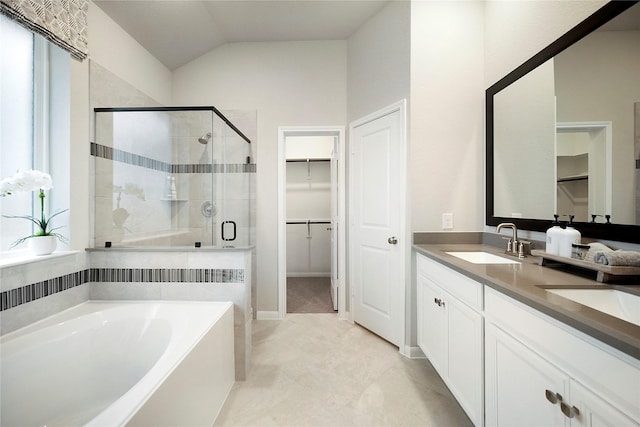 bathroom featuring vaulted ceiling, vanity, and shower with separate bathtub