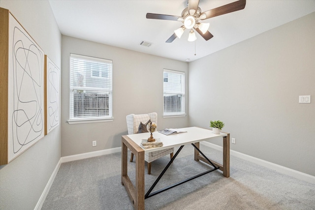 carpeted office featuring ceiling fan