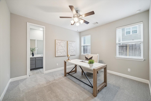 office space with ceiling fan and light colored carpet