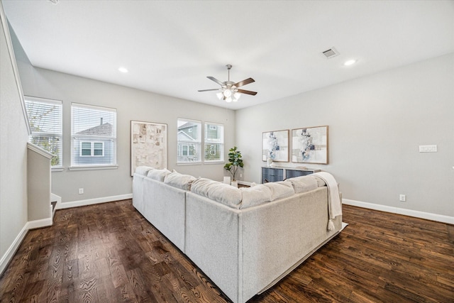 living room with ceiling fan and dark hardwood / wood-style floors