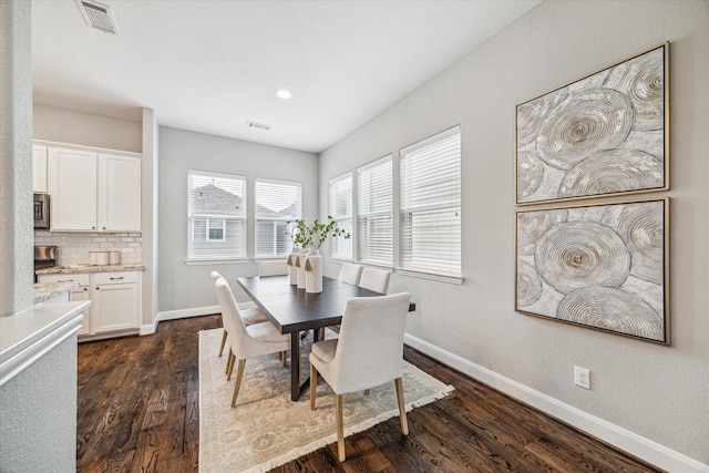 dining area with dark hardwood / wood-style floors