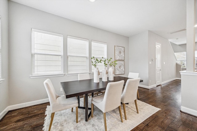 dining area featuring a healthy amount of sunlight and dark hardwood / wood-style floors