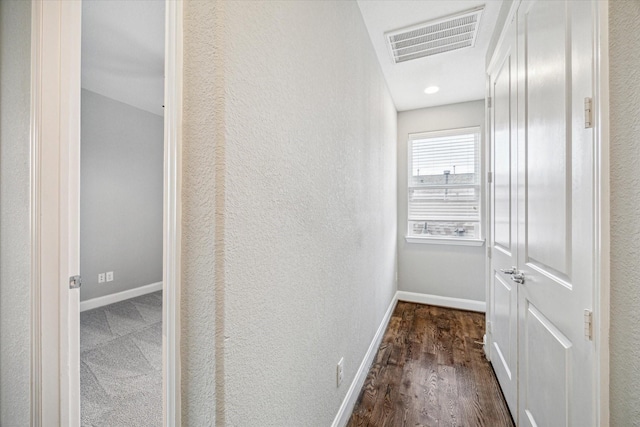 corridor featuring dark hardwood / wood-style floors