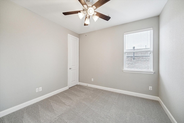 carpeted empty room featuring ceiling fan