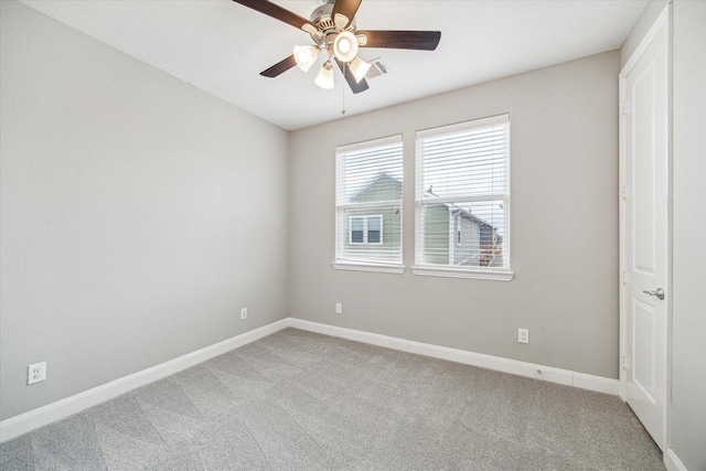 spare room featuring carpet floors and ceiling fan