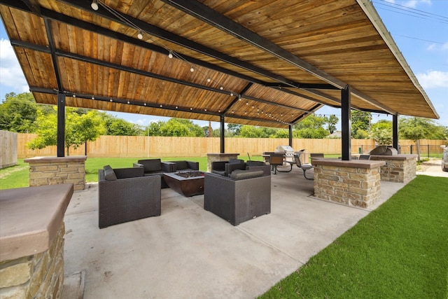 view of patio / terrace featuring an outdoor living space with a fire pit and area for grilling