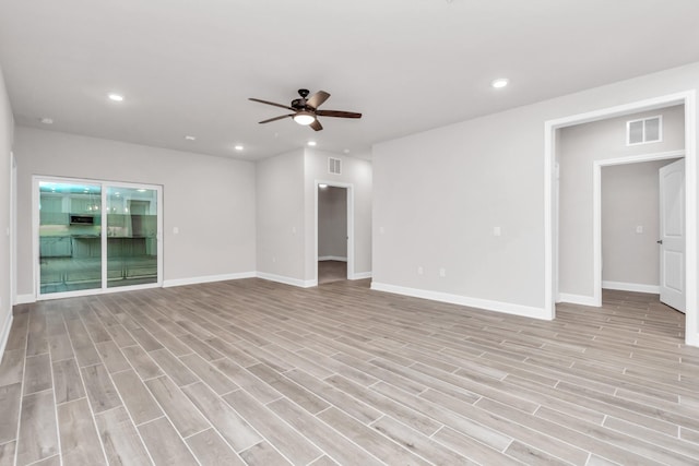 unfurnished living room featuring ceiling fan and light wood-type flooring