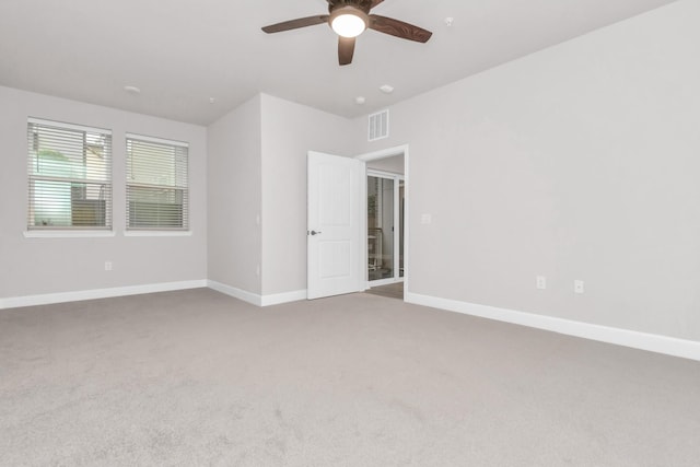 spare room with ceiling fan and carpet flooring