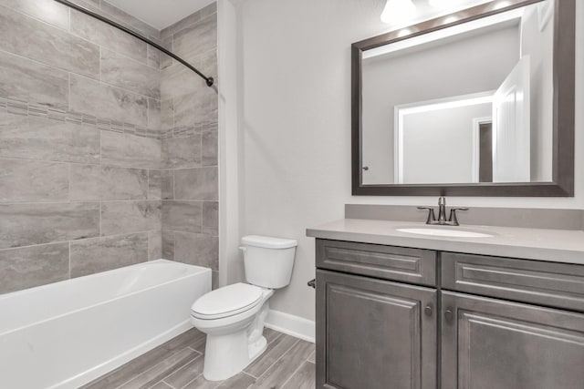 full bathroom with toilet, tiled shower / bath, and vanity