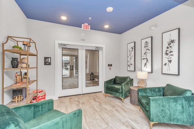 sitting room featuring french doors and light wood-type flooring