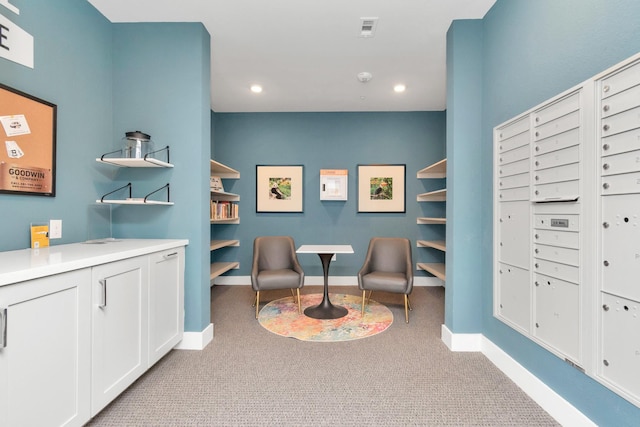 living area with mail boxes and light carpet