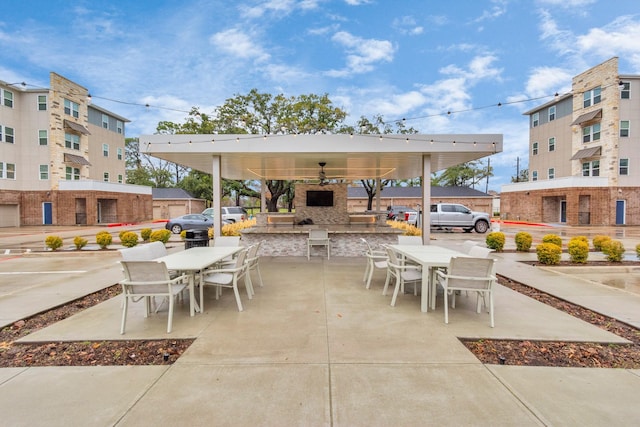 view of patio / terrace featuring an outdoor stone fireplace and a gazebo