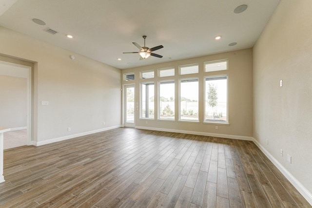 empty room with ceiling fan and wood-type flooring